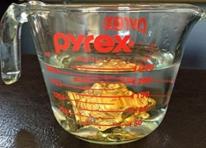 pyrex measuring cup with water and buddha